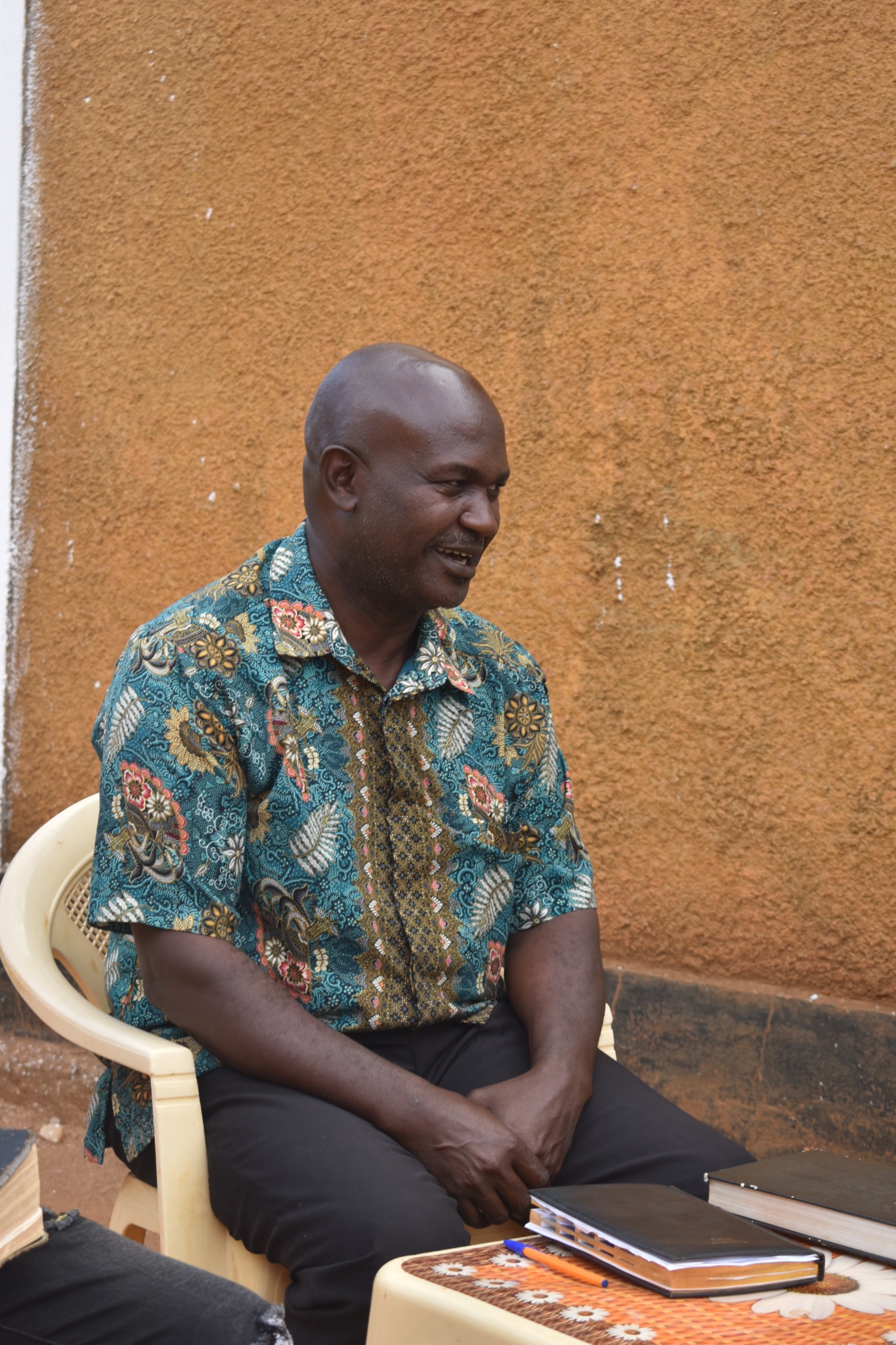 Man seated outdoors in conversation
