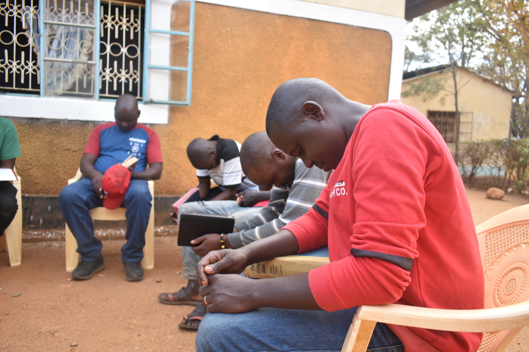 People praying together with Bibles